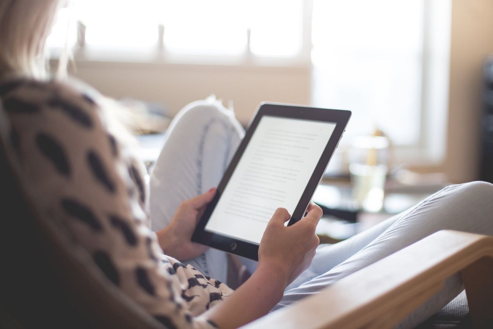 A child reading on a Kindle